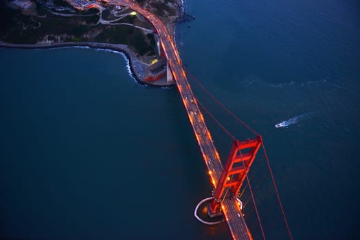 an aerial view of golden gate bridge in san francisco during sunset, taken from a helicopter