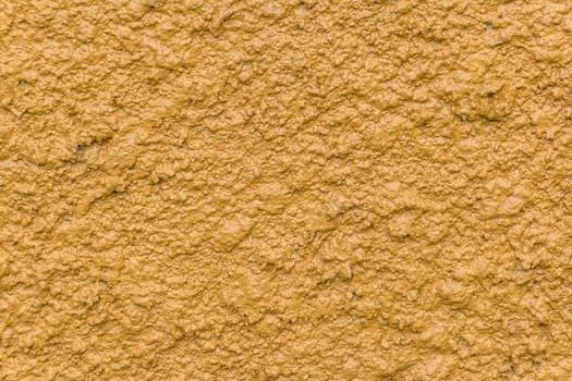 Yellow bump plaster wall coating with oil paint texture