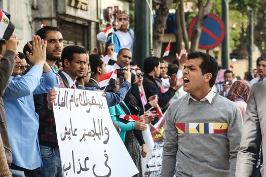 EGYPT, Cairo: A man yells  and walks in front of the protest line during a demonstration in Cairo, Egypt on April 4, 2016, over the uselessness of their degrees after they cannot find jobs. The protesters are demanding to be appointed to jobs in the state administration. 