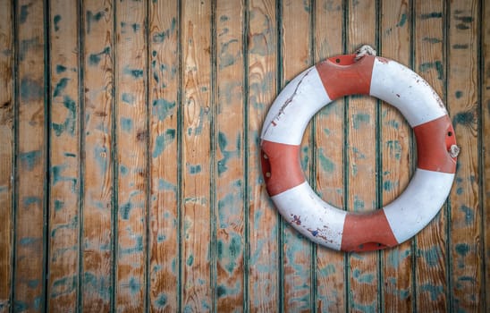 Vintage Lifebuoy Hanging On A Rustic Wooden Wall With Copy Space