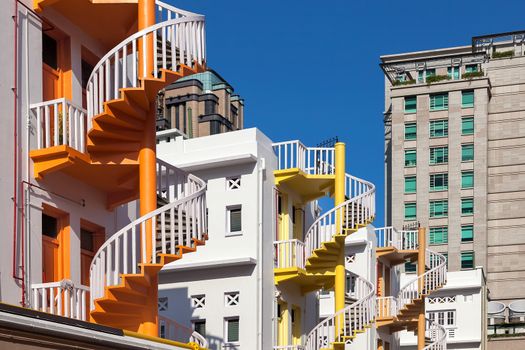 Colorful Row of restored spiral staircase in the back alleyway of Bugis Village in Singapore