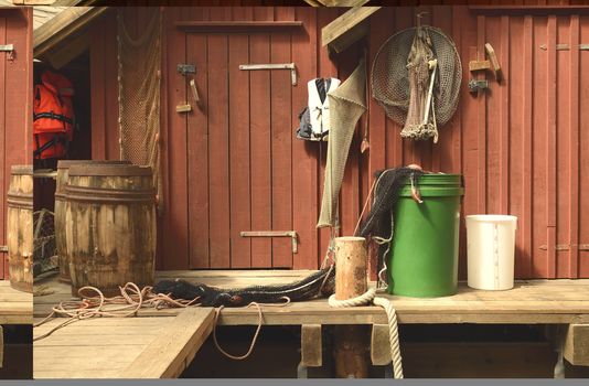 A set of fishing gear and net hanging on the wall in a Swedish fiserman village.