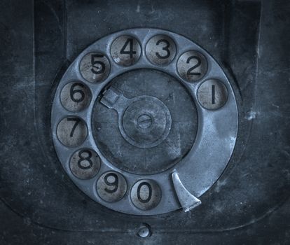 Closeup of vintage telephone dial, scratched and filthy