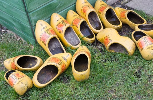 Pile of Dutch clog/Wooden Shoes outside in the rain