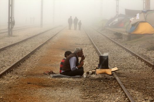 GREECE, Idomeni: Refugees and migrants go on their daily life at a makeshift camp  on April 4, 2016 at Greece-Macedonian border, near Idomeni village where thousands of people are stranded by the Balkan border blockade. Migrants return from Greece to Turkey begun under the terms of an EU deal that has worried aid groups that same day, as Athens struggles to manage the overload of desperate people on its soil. Over 51,000 refugees and migrants seeking to reach northern Europe are stuck in Greece, after Balkan states sealed their borders. Under the agreement, designed to halt the main influx which comes from Turkey, all irregular migrants arriving since March 20 face being sent back, although the deal calls for each case to be examined individually. For every Syrian refugee returned, another Syrian refugee will be resettled from Turkey to the EU, with numbers capped at 72,000.