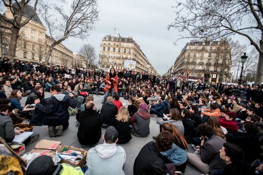 FRANCE, Paris: A woman addresses to a crowd of people as hundreds of militants of the Nuit Debout or Standing night movement hold a general assembly to vote about the developments of the movement at the Place de la Republique in Paris on April 4, 2016. It has been five days that hundred of people have occupied the square to show, at first, their opposition to the labour reforms in the wake of the nationwide demonstration which took place on March 31, 2016. 