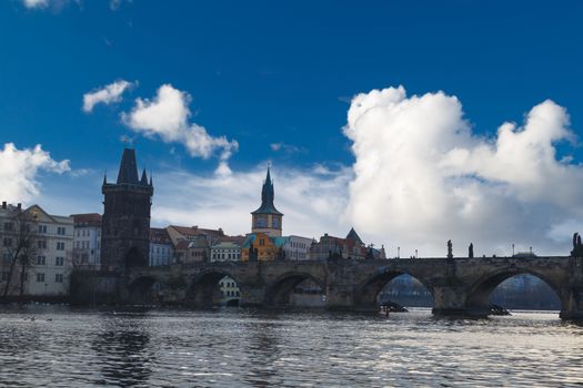 PRAGUE, CZECH REPUBLIC , DECEMBER 31, 2015 : Side view of famous historical Charles Bridge with its gothis architecture in Prague, on cloudy sky background.