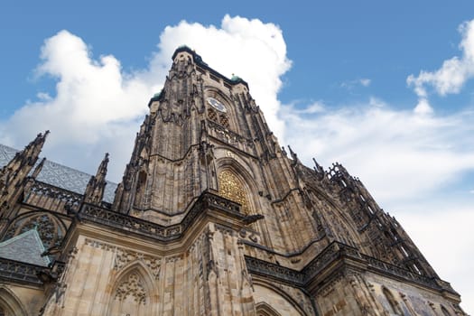 Close up detailed view of historical gothic St. Vitus Cathedral in old town of Prague, found in 1344, on cloudy blue sky background.