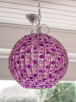 Homemade lamp with purple glass hanging from the ceiling
