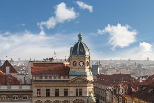 General top view of Prague cityscape view with historical gothic buildings around, on cloudy sky background.