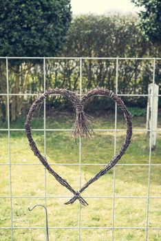 Nature heart made of willow twigs in a garden
