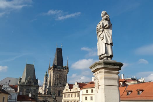 Close up detailed view of historical gothic granit sculptures on Charles Bridge in Prague, on bright blue sky background.