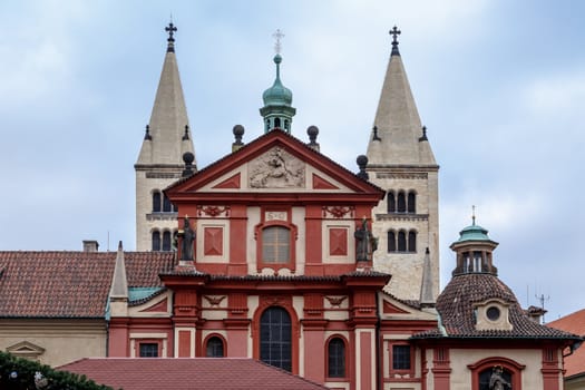 Front view of St George Basilica, the oldest living church built within Prag Castle, on cloudy sky background.