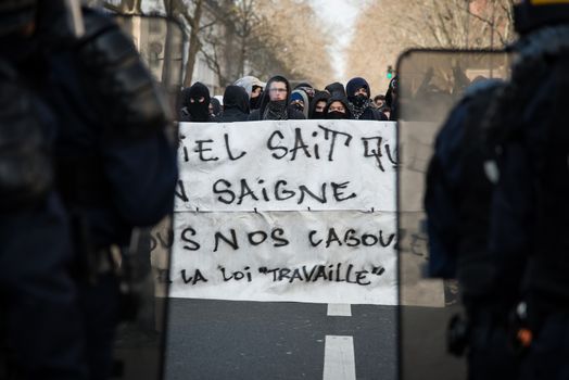 FRANCE, Paris: Protesters hold a banner as pupils, students and unionists demonstrate against government's planned labour reforms, in Paris on April 5, 2016 