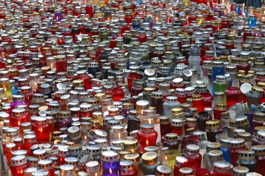 Memorial candles shining at the cemetery on the All Saints Day
