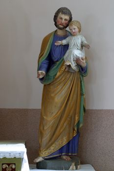 Saint Joseph holding baby Jesus