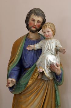Saint Joseph holding baby Jesus