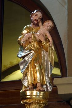 Saint Joseph holding baby Jesus