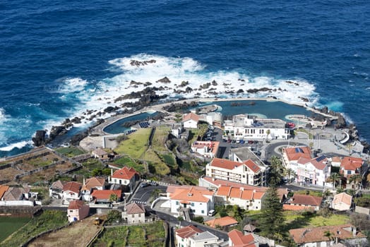 View of the village of Porto Moniz with lava-rock pool, Madeira Island, Portugal