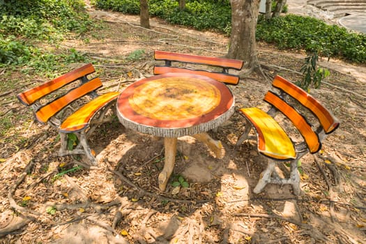 table and three benches in the park