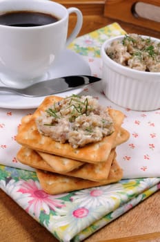 Appetizer of fish paste (forshmak) on a cracker with a cup of coffee