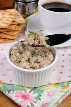 Appetizer of fish paste (forshmak) into a bowl on a tray with a cup of coffee