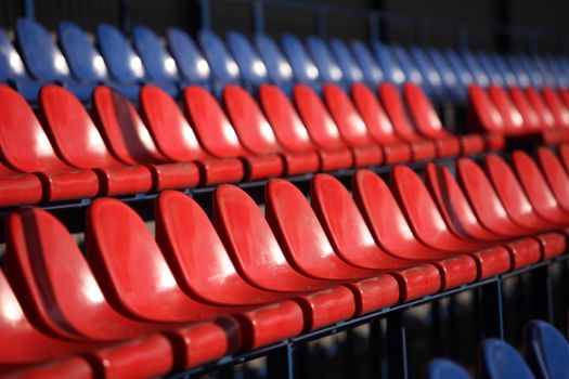 Red chairs bleachers in stadium close to