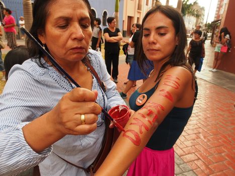 PERU, Lima: A protester has paint on her arms reading 'No Keiko' as dozens of thousands of people took to the streets on April 5, 2016 in Lima against his daughter Keiko Fujimori who has a strong led in the polls, just five days before the presidential election in Peru. The right-wing candidate is currently in first place, with roughly 40 percent support ahead of the vote on April 10. But if she does not win at least 50 percent there will be a run-off in June.Protesters denouced the Fujimoru dictatorship.