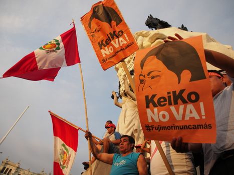 PERU, Lima: Protesters wave flags and signs reading 'Keiko it does not work. Never again Fujimoris' as dozens of thousands of people took to the streets on April 5, 2016 in Lima against his daughter Keiko Fujimori who has a strong led in the polls, just five days before the presidential election in Peru. The right-wing candidate is currently in first place, with roughly 40 percent support ahead of the vote on April 10. But if she does not win at least 50 percent there will be a run-off in June.Protesters denouced the Fujimoru dictatorship.