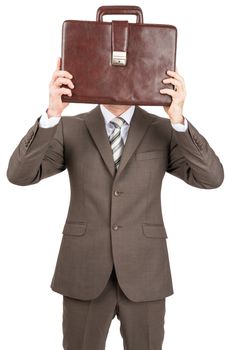 Businessman in suit covered her head with leather briefcase. Isolated on white background