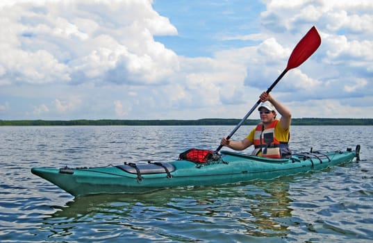 man canoeing on a lake