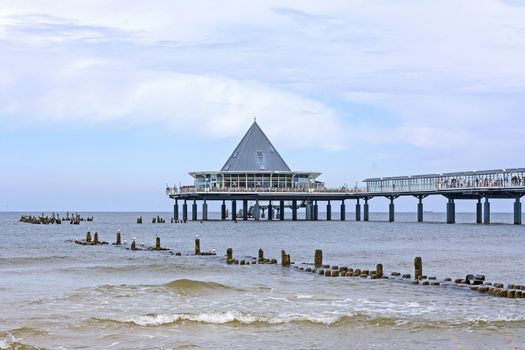 Heringsdorf, Usedom, Germany - June 27, 2012: Famous pier with restaurant building at its end. A tourist hotspot at the beach / baltic sea.