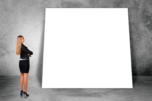 Big blank banner with businesswoman on grey wall background