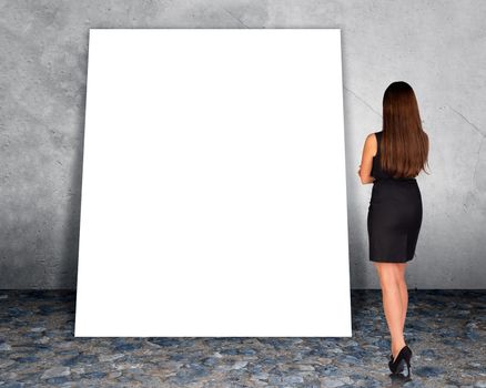 Big blank banner with businesswoman on grey wall background, rear view
