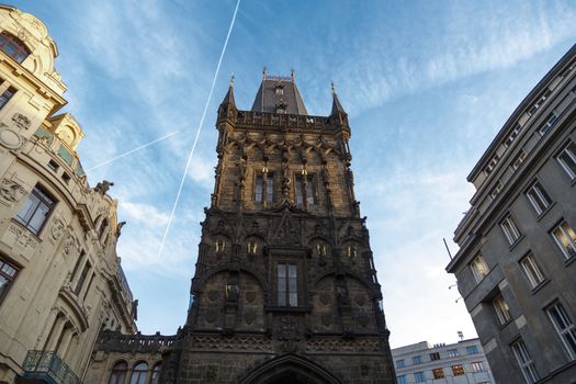 View of historical gothic Powder Tower also known as Powder Gate in old town of Prague, on cludy blue sky background.