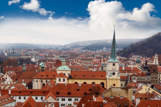 Top cityscape view of Prague with historical gothic architecture, on cludy blue sky bakcground.