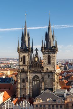 View of historical gothic Church of Our Lady Before Tyn with the name of Tyn Church in Prague Old Town, on bright blue sky background.