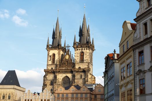 View of historical gothic Church of Our Lady Before Tyn with the name of Tyn Church in Prague Old Town, on bright blue sky background.