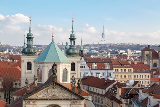 Historical gothic cityscape view from Old Town Bridge Tower in Prague, on cloudy sky background.