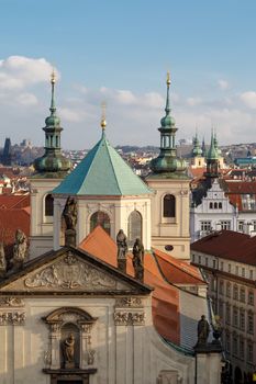 Historical gothic cityscape view from Old Town Bridge Tower in Prague, on cloudy sky background.