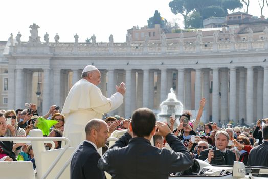 VATICAN, Vatican City: Pope Francis blesses pilgrims from his popemobile in St. Peter' Square at the end of his weekly general audience in Vatican City on April 6, 2016.