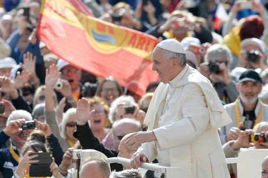 VATICAN, Vatican City: Pope Francis blesses pilgrims from his popemobile in St. Peter' Square at the end of his weekly general audience in Vatican City on April 6, 2016.