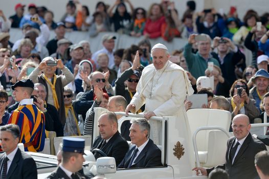 VATICAN, Vatican City: Pope Francis blesses pilgrims from his popemobile in St. Peter' Square at the end of his weekly general audience in Vatican City on April 6, 2016.