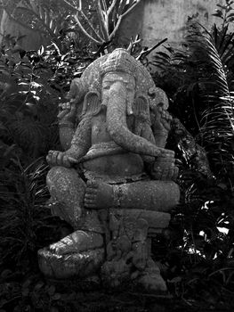 This is a statue of the hindu god Ganesh. He is the Lord of Good Fortune who provides prosperity, fortune and success.  He is the Lord of Beginnings and the Remover of Obstacles of both material and spiritual kinds.
He was beheaded by Shiva for not being aloud to pass through the door leading to Parvati's bathroom, later his creator Parvati attached a new head on the body, which was a elephants head.

because he was known as Parvati's doorkeeper, which is why he's often faced to doorways, to keep out the unworthy.