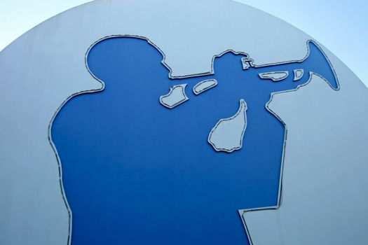 A silhouette of a man playing trumpet