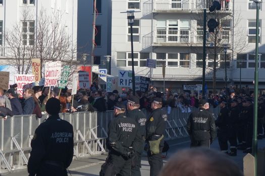 ICELAND, Reykjavik: Police stand guard as thousands rally in Reykjavik, Iceland on April 4, 2016, calling for Icelandic Prime Minister Sigmundur David Gunnlaugsson's resignation. The protest follows the Panama Papers' revelation of a global scandal surrounding secret financial dealings. The following day, Gunnlaugsson would agree to step down, though he would reportedly retain his title until a replacement has been named.