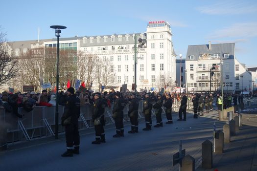 ICELAND, Reykjavik: Police stand guard as thousands rally in Reykjavik, Iceland on April 4, 2016, calling for Icelandic Prime Minister Sigmundur David Gunnlaugsson's resignation. The protest follows the Panama Papers' revelation of a global scandal surrounding secret financial dealings. The following day, Gunnlaugsson would agree to step down, though he would reportedly retain his title until a replacement has been named.