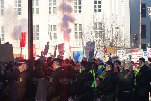 ICELAND, Reykjavik: A protester lights a flare as thousands rally in Reykjavik, Iceland on April 4, 2016, calling for Icelandic Prime Minister Sigmundur David Gunnlaugsson's resignation. The protest follows the Panama Papers' revelation of a global scandal surrounding secret financial dealings. The following day, Gunnlaugsson would agree to step down, though he would reportedly retain his title until a replacement has been named.