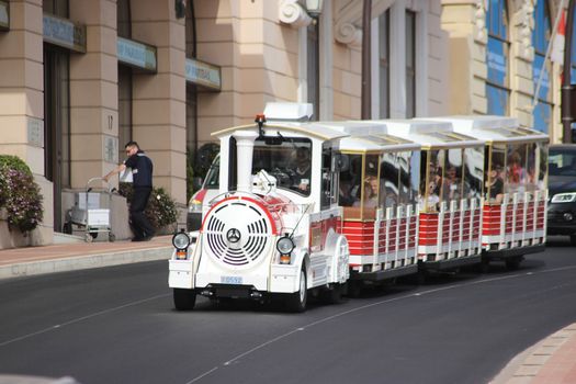 Monte-Carlo, Monaco - April 6, 2016: Red and White Trackless Train for Sightseeing in Monaco on the Street of Monte-Carlo, Monaco in the south of France