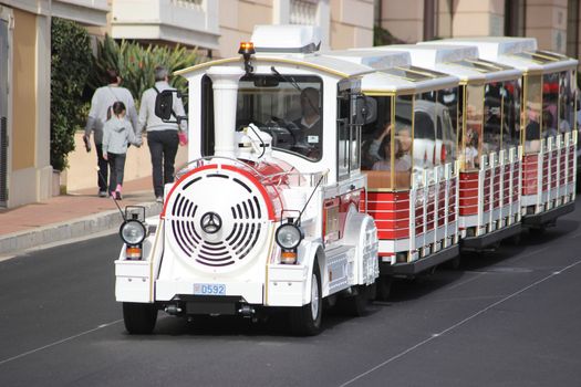Monte-Carlo, Monaco - April 6, 2016: Red and White Trackless Train for Sightseeing in Monaco on the Street of Monte-Carlo, Monaco in the south of France